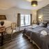 Kragerup Gods in Ruds-Vedby guest room with patterned accent wall, twin bed, desk and chairs