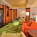 Fairfield Inn and Suites by Marriott Grand Island lounge with orange seating and green patterned carpet