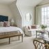 Gardiner House in Newport guest room with king bed, loveseat, sitting area and large window