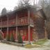 Black Bear Lodge Motel in Slade, rustic log-style motel exterior with covered porch and stairway
