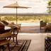 Four Seasons Safari Lodge Serengeti terrace with pool and Serengeti savanna view in Kilimafedha