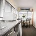 Trafalgar Lodge Nelson kitchenette with table, chairs and bright window view
