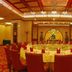 Fuhong International Hotel in Liaoyang banquet room with round dining table and red chairs