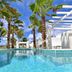 Coral Beach Club Villas & Marina in Upper Prince's Quarter, poolside view with palm trees and oceanfront cabana