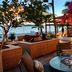 Holland House Beach Hotel in Philipsburg with oceanfront terrace seating, fire pit, and tropical flowers