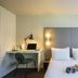 Campanile Melun Sud - Dammarie les Lys guest room with double bed, desk and window light in Dammarie-les-Lys