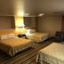 Super 8 by Wyndham Coeur d'Alene guest room with three beds and a window air conditioner