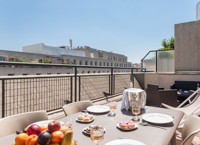 Residhotel Le Grand Prado Marseille rooftop terrace with table setting and city view