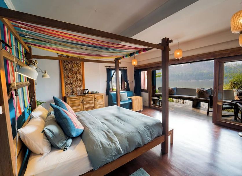 Ock Pop Tok Mekong Villa in Luang Prabang guest room with canopy bed and Mekong River view