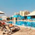 TIME Grand Plaza Hotel in Dubai with an outdoor pool and sun loungers beside a poolside bar