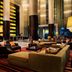 JW Marriott Hotel Bengaluru lobby lounge with modern seating, chandeliers, and red patterned carpet