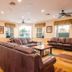 Berkley Lake Townhomes in Kissimmee lounge with leather sofas, coffee tables, windows and ceiling fans