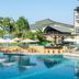 Le Méridien Khao Lak Resort & Spa pool with swim-up bar, palm trees and ocean view in Khao Lak