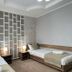 Kausar Hotel in Bishkek twin room with two single beds, nightstands, and geometric accent wall