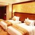 Golden Ray International Hotel in Yichang guest room with two twin beds and a writing desk