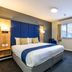 Days Inn by Wyndham London Stansted Airport guest room in Bishop's Stortford with bed, desk and window