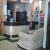 Hotel Savoy in La Paz lobby with front desk, beige armchairs and tourist information sign