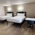 Motel 6-Orange, CA - Anaheim guest room with two beds, desk, and wood-look flooring in Orange