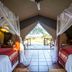 Mbuzi Mawe Serena Camp Serengeti tented room with twin beds and open view to the savanna