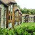 Hôtel Lac Carling Golf & Spa in Grenville with chalet-style rooms beside a lush green lawn