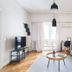 Central Cozy Apartments in Plaka by Upst living room with sofa, TV, desk and balcony doors in Athens
