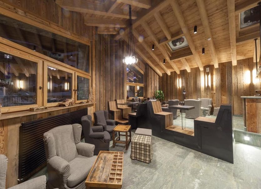 Hotel Maison Saint Jean lounge in Courmayeur with cozy wood interior and modern seating