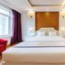 Home Hotel Hanoi guest room with king bed, large window, desk, and framed wall art in Hanoi