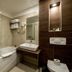 Hotel Blanca Resort & Spa in Šišava bathroom with bathtub, vessel sink, and wood-paneled wall niche