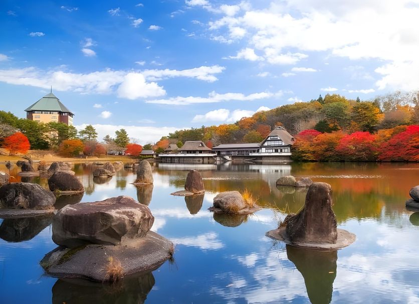 Aomoriya by Hoshino Resorts in Misawa with pond, rocks, autumn trees, and blue sky reflections