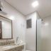 Mar Hotel bathroom in Balneário Camboriú with granite sink, toilet, shower and glass partition