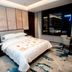 Zhongyuan Hotel, Anyang guest room with king bed, large window city view, and patterned carpet