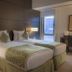 Asdal Boutique Hotel Seef, Manama twin room with two beds and city-view window