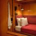 West Village Eurohostel, New York: cozy wood-paneled bunk-style sleeping berth with red bedding and wall lamp