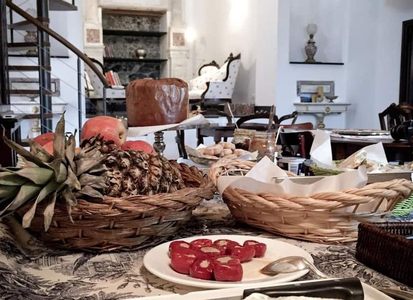 B&B La Madonetta in Levanto breakfast table with baskets of pastries and fruit in a bright dining room
