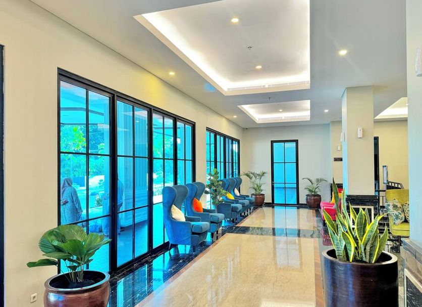 d'primahotel Kualanamu Medan lobby corridor with blue seating and large windows in Medan