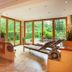 Hotel Pass Lueg spa lounge with loungers and floor-to-ceiling garden views in Golling an der Salzach
