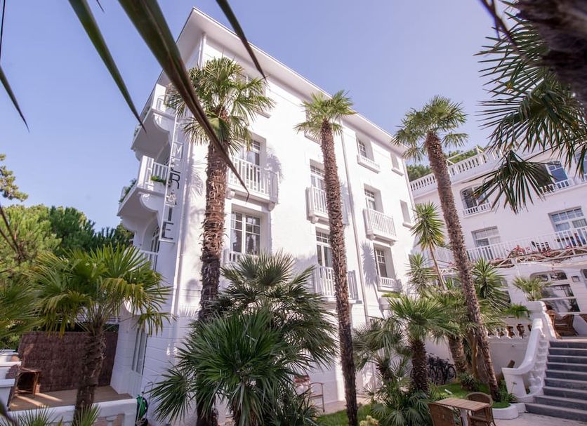La Palmeraie in La Baule-Escoublac, white hotel facade with tall palm trees and balconies