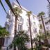 La Palmeraie in La Baule-Escoublac, white hotel facade with tall palm trees and balconies