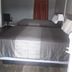 Essex Motel Alturas room with two beds, gray walls, and a red curtain