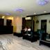 Hotel The Great Ananda Haridwar lobby with seating area, glossy marble floor, and decorative ceiling lights