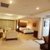 Qilu International Hotel, Harbin: spacious guest room with sofa seating, bed, and warm lighting