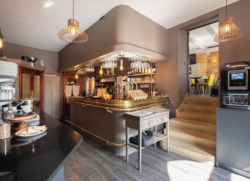 Hotel La Couleuvrine in Sarlat-la-Canéda bar with brass counter and stairway to dining room