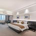 Beijing Lian Jie Hotel room with king bed, desk seating area, and large window in Beijing