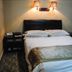 Orange Crystal Hotel Xuzhou Suning Plaza guest room with double bed and wall lamps in Xuzhou