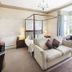 Hawksmoor Guest House in Windermere bedroom with four-poster bed, sofa, bay window and armchair
