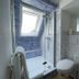 Haus Hohensee, Clausthal-Zellerfeld: modern bathroom with glass shower, wall-hung sink and skylight