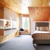 Auberge du Lac-a-l'Eau-Claire room in Saint-Alexis-des-Monts with two beds and wood-paneled sloped ceiling