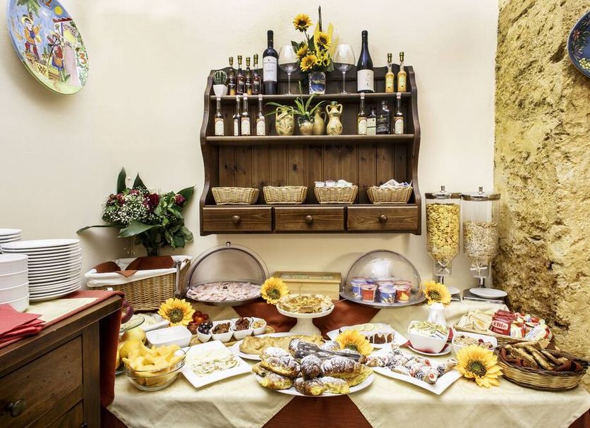 Locanda Scirocco in Castellammare del Golfo breakfast buffet with pastries, fruit, and drinks