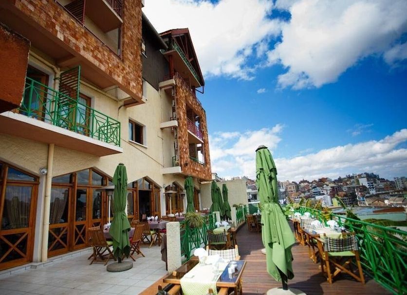 Palissandre Antananarivo terrace with outdoor tables, umbrellas and city views in Antananarivo