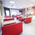 Lotus Hotel Istanbul lobby with red seating, tiled floor, brick accent wall, and reception area